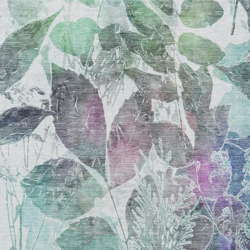 Close-up botanical leaf area rug pattern in teal, gray, and hints of purple and pink