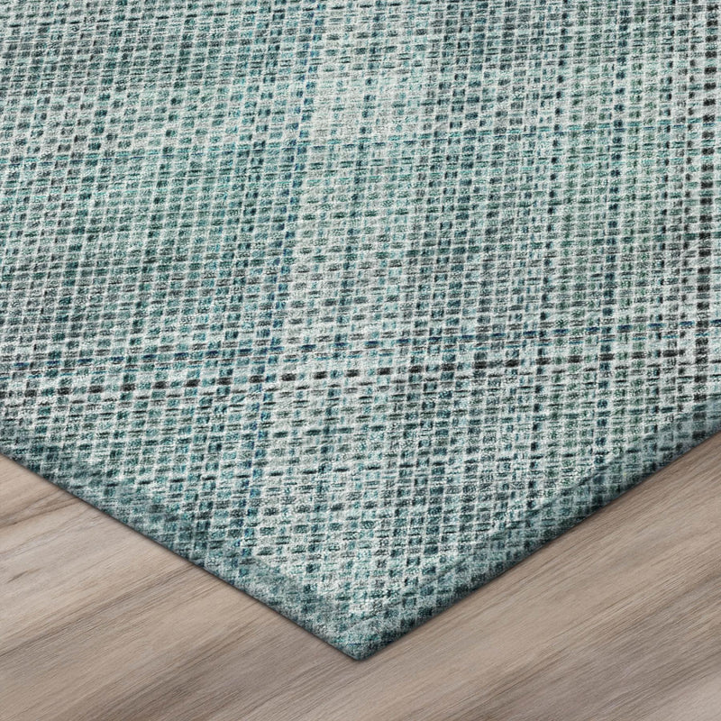 Teal blue and silver plaid area rug corner with textured low-pile surface