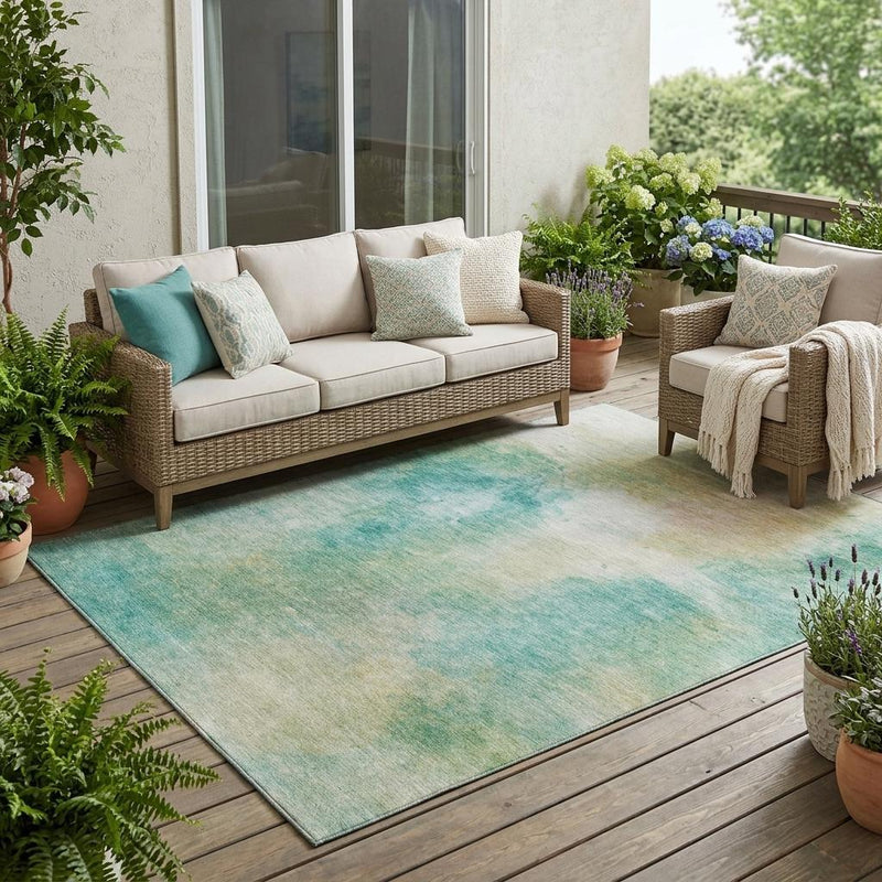 Aqua and teal abstract area rug with washed watercolor texture and rectangular shape.
