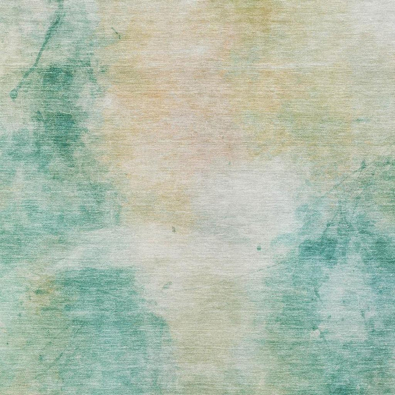 Close-up of aqua and teal abstract rug with faded watercolor wash and textured weave.