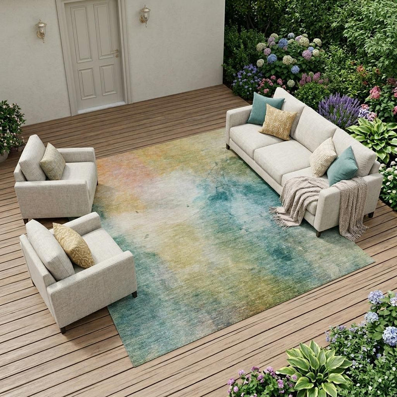 Indoor outdoor rectangular rug with abstract teal blue and peach wash pattern
