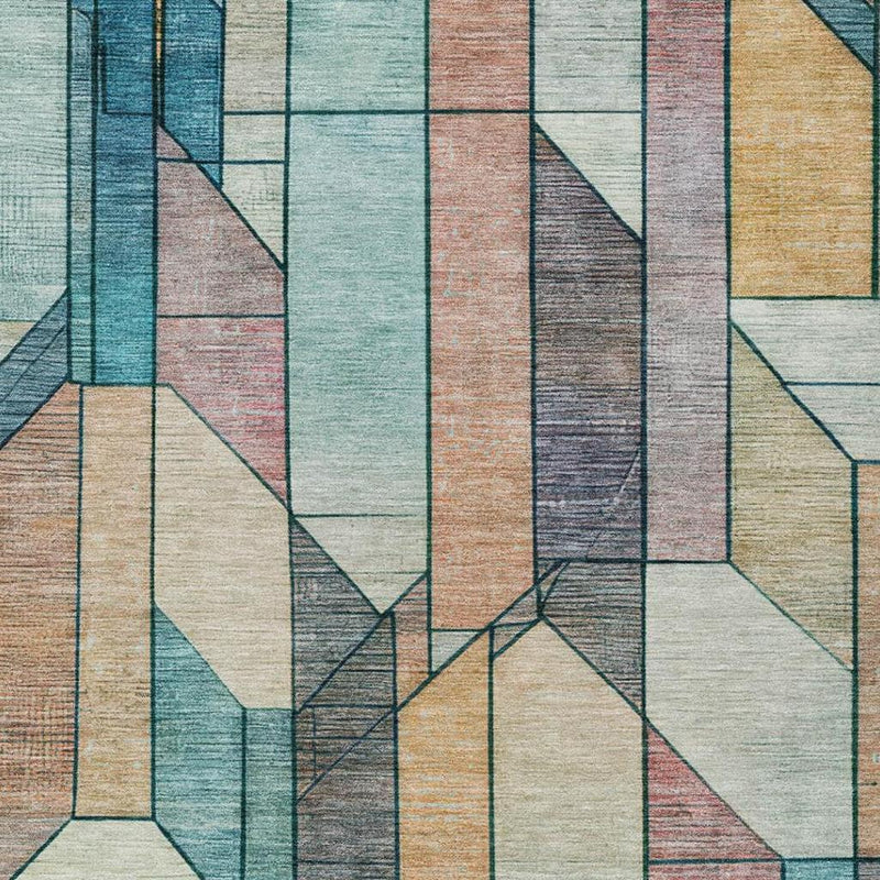 Close-up of geometric area rug in teal, gray, beige, and rust tones
