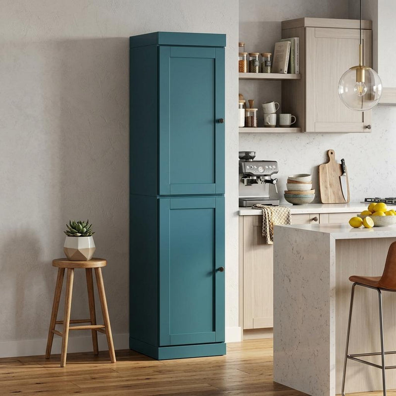 Teal blue wooden pantry cabinet standing in a kitchen space