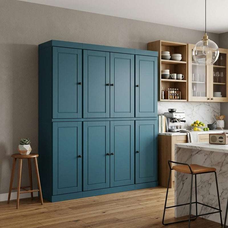 Teal blue pantry storage cabinet with 8 panel doors and black round knobs