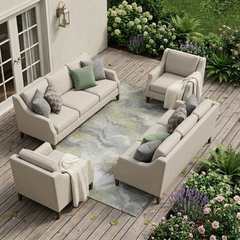 Abstract area rug with washed pattern in green, ivory, and gray, outdoor-ready bound edges