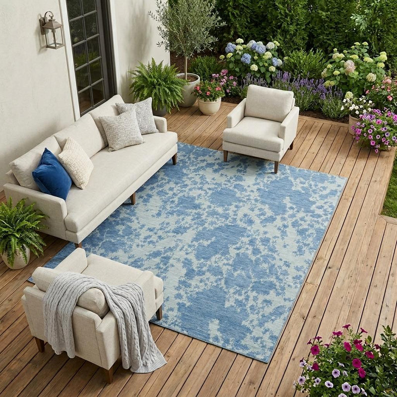 Sky-blue abstract area rug with woven border edge and distressed pattern