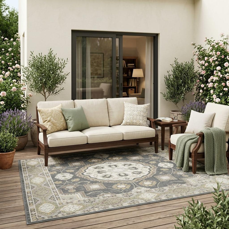 Indoor outdoor area rug with graphite and gray floral medallion and decorative border