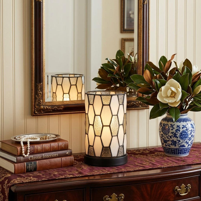 Bronze abstract cylinder table lamp with geometric stained-glass shade and dark base