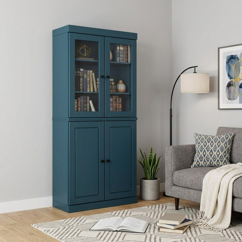 Teal blue wood bookcase with glass top doors and paneled cabinet doors in a living room