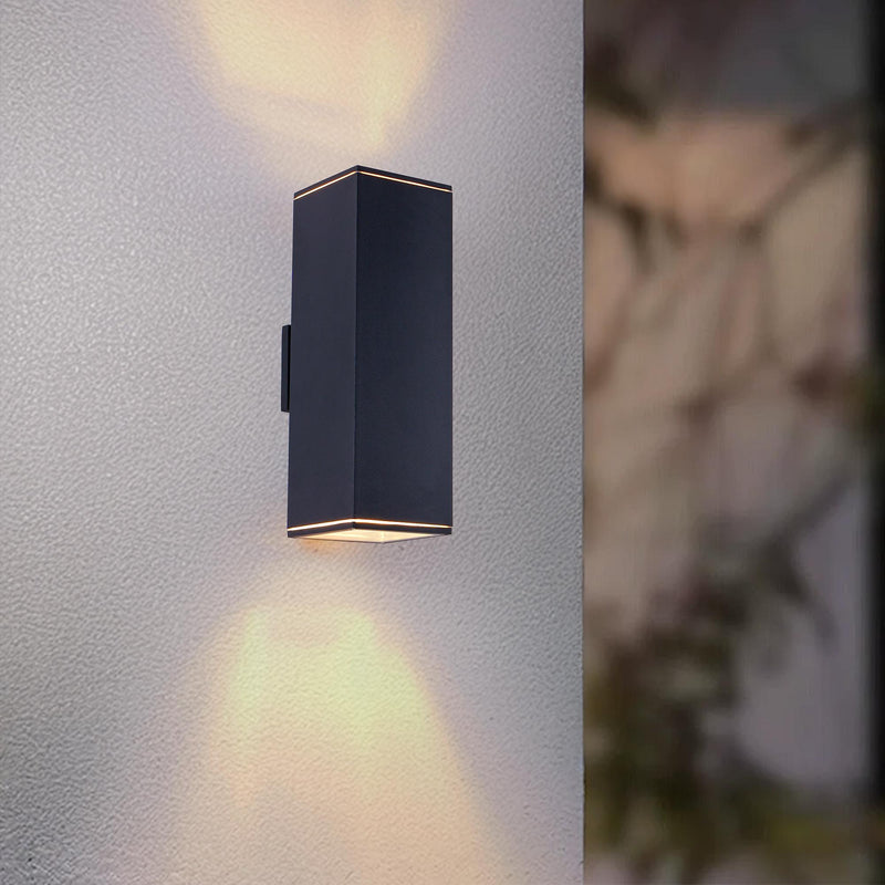 Black outdoor wall lantern light with warm downlight and dark metal shade
