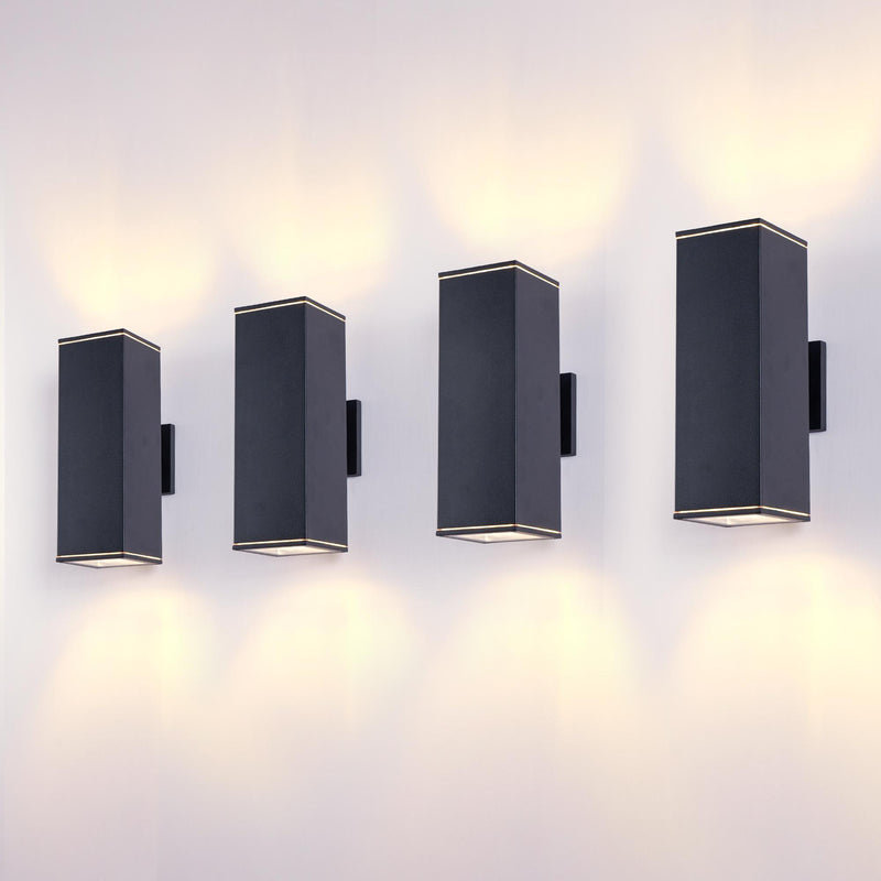 Set of outdoor wall light fixtures with dark frames, glowing warm through glass