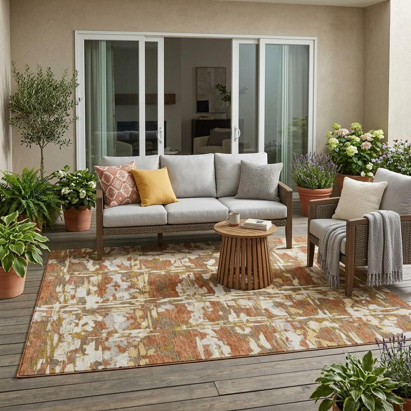 Abstract area rug on patio floor with orange-brown distressed grid pattern