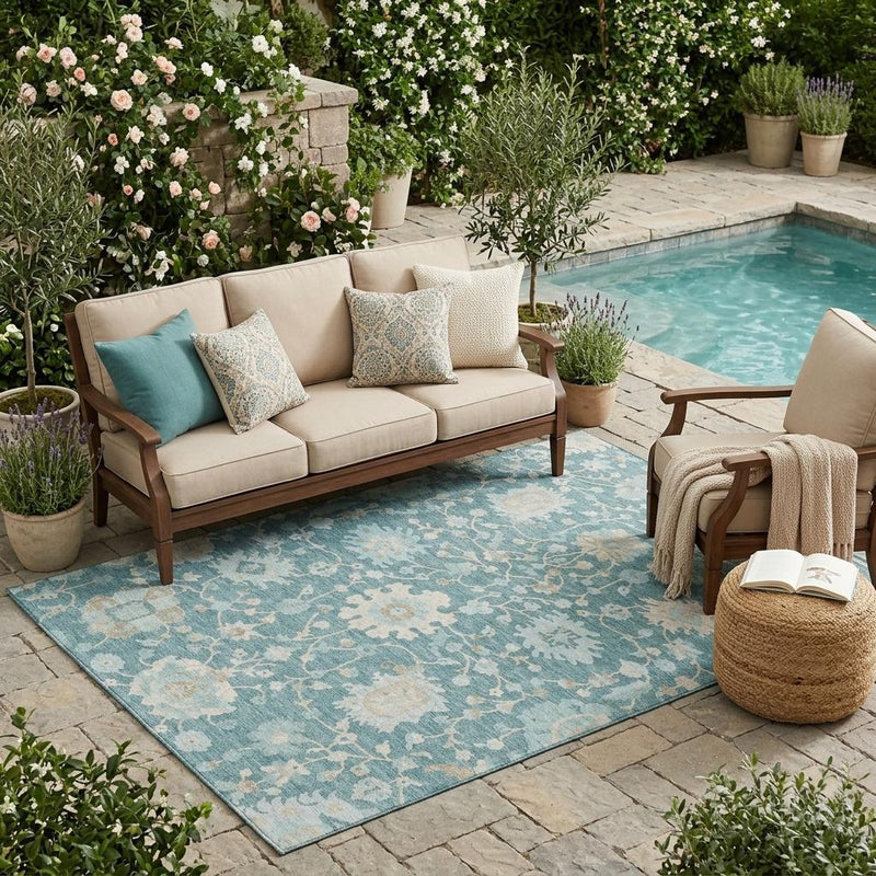 Teal blue floral area rug with light cream medallions and distressed pattern