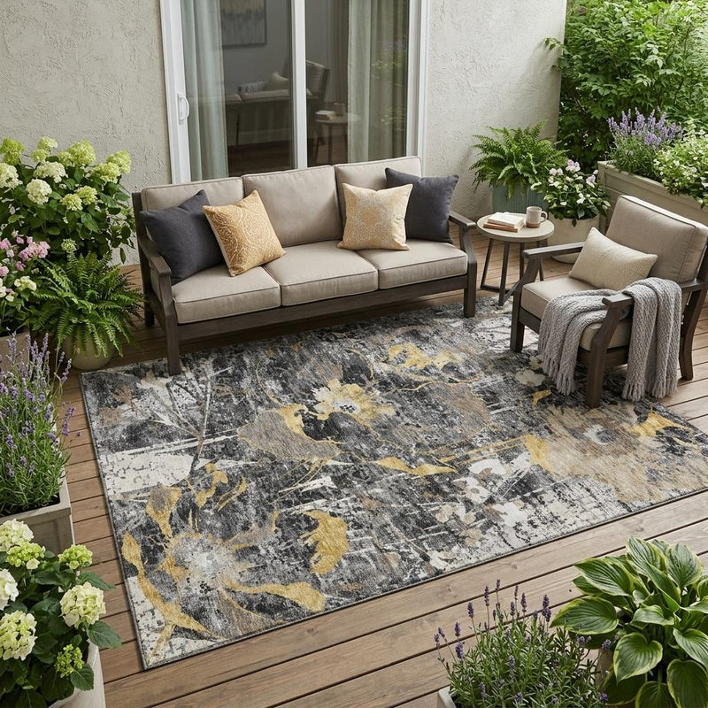Indoor outdoor area rug with black and graphite base and gold abstract floral design