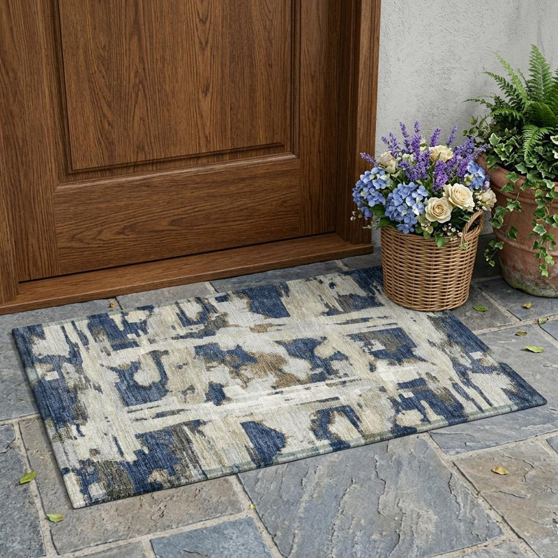 Blue abstract area rug in indoor/outdoor setting, rectangular with distressed design