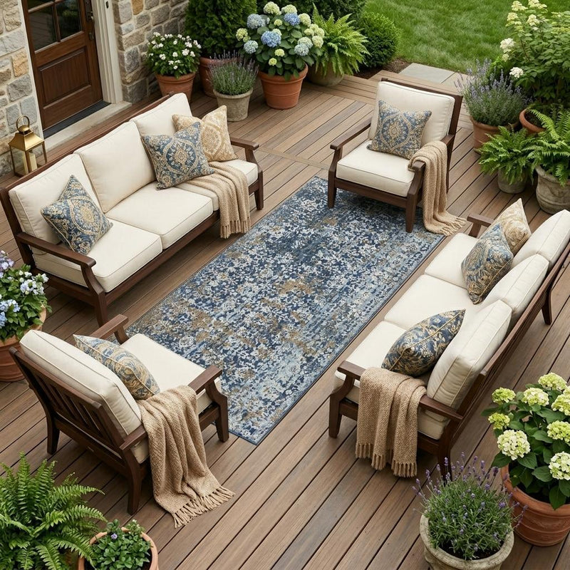 Navy and blue abstract area rug on an outdoor patio between seating cushions