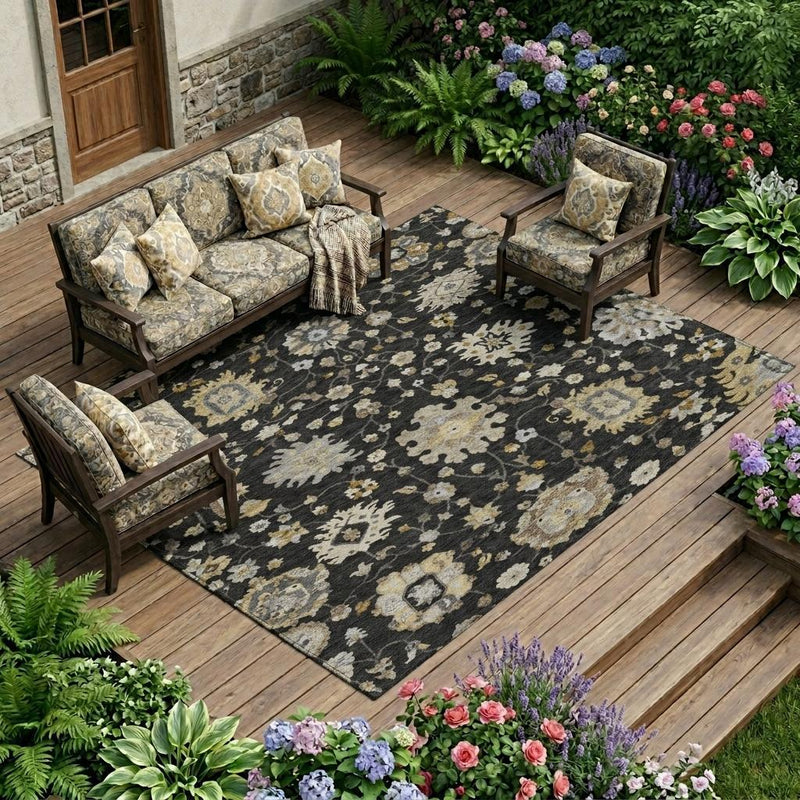 Outdoor-ready area rug with black background and light floral medallion design
