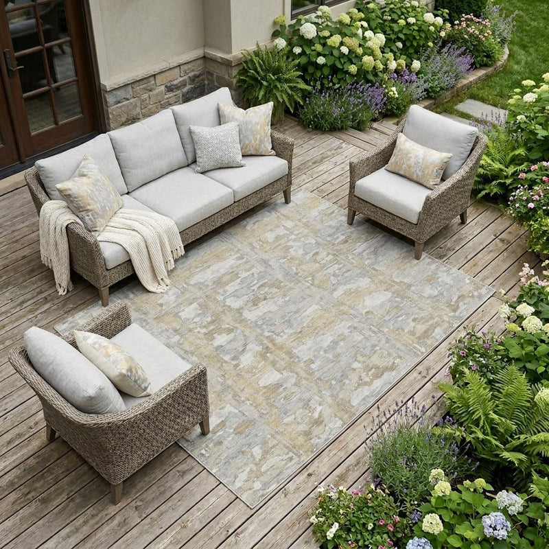 Ivory and silver abstract area rug on outdoor wood deck flooring.