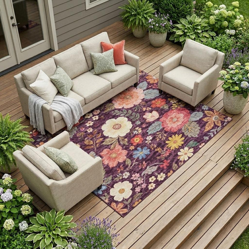 Plum purple floral area rug on a wooden deck with outdoor seating sets nearby