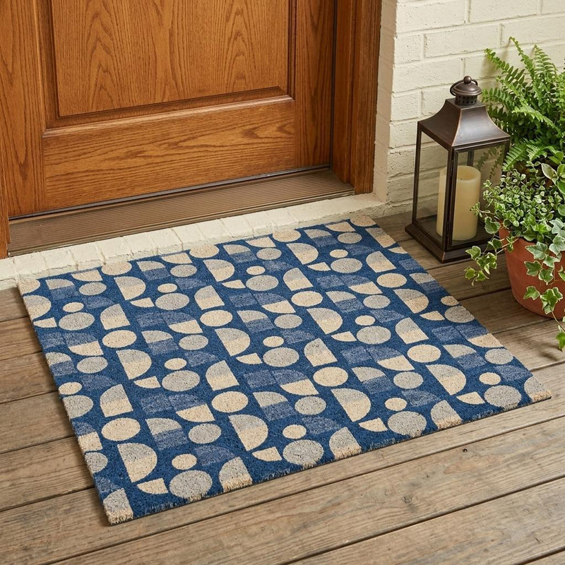 Navy blue geometric area rug with beige shapes on indoor patio floor