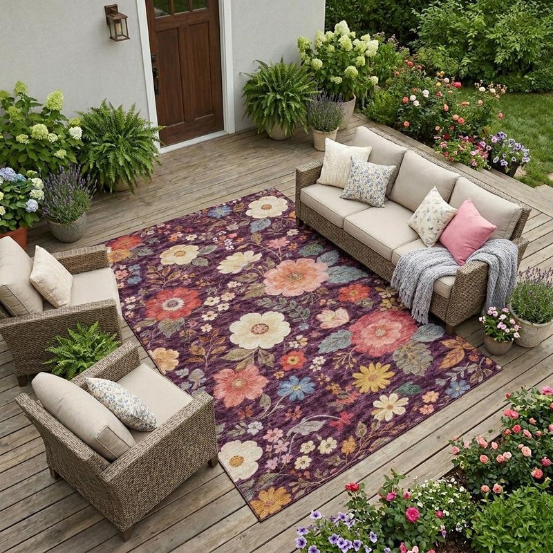 Plum floral area rug with multicolor blooms, rectangular shape on outdoor deck flooring