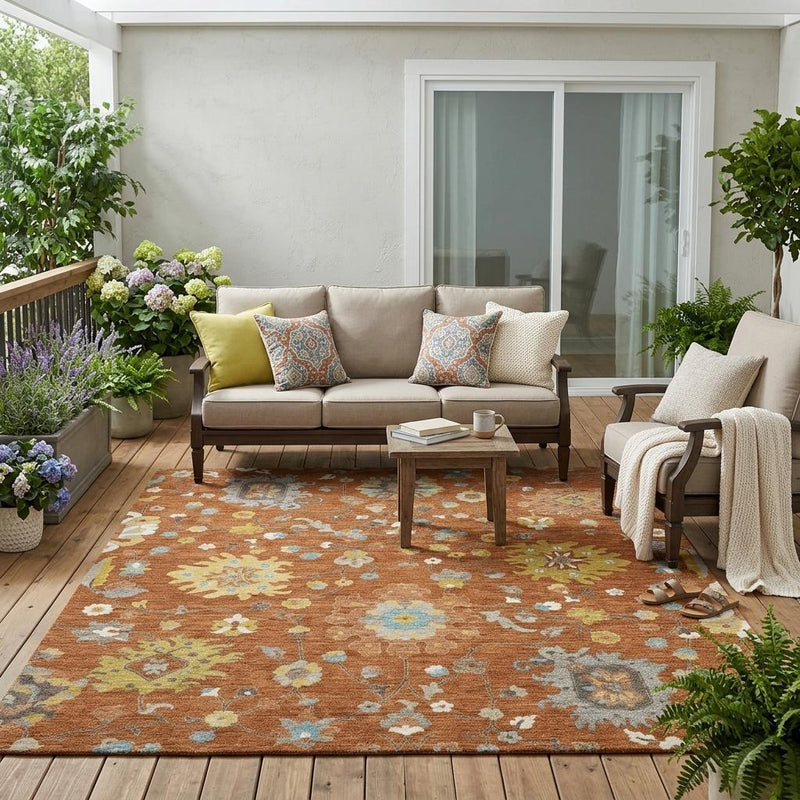 Brown floral area rug outdoors with multicolor blossoms under a patio seating area