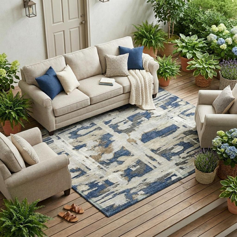Indoor/outdoor area rug in navy and blue abstract pattern on patio floor