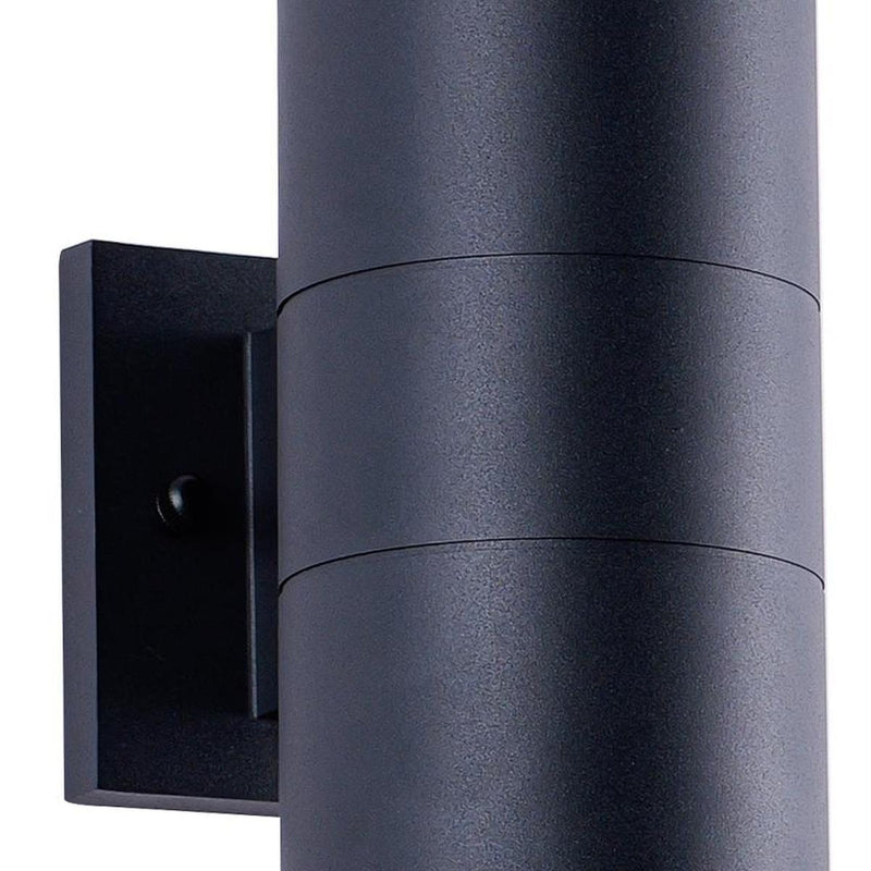 Black cylindrical outdoor wall light detail: textured tube shade beside square mounting plate