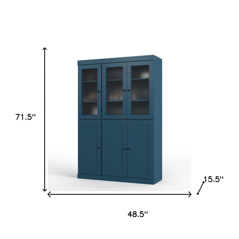 Teal blue wood pantry cabinet with three glass doors and three panel doors