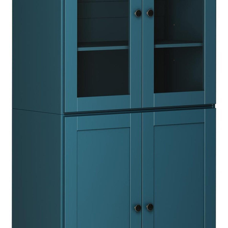 Teal blue wood pantry cabinet detail with two glass door sections and metal knobs