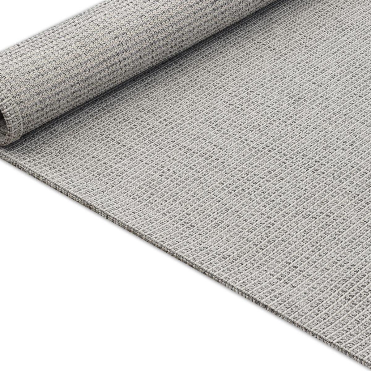 Gray indoor outdoor area rug with woven texture, corner edge visible