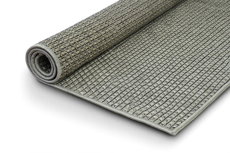 Rolled gray indoor/outdoor area rug, textured weave with bound edge visible