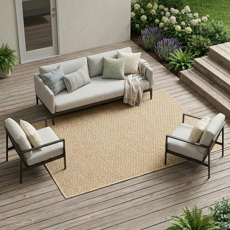 Beige flat-woven area rug on patio deck, center placement with outdoor seating