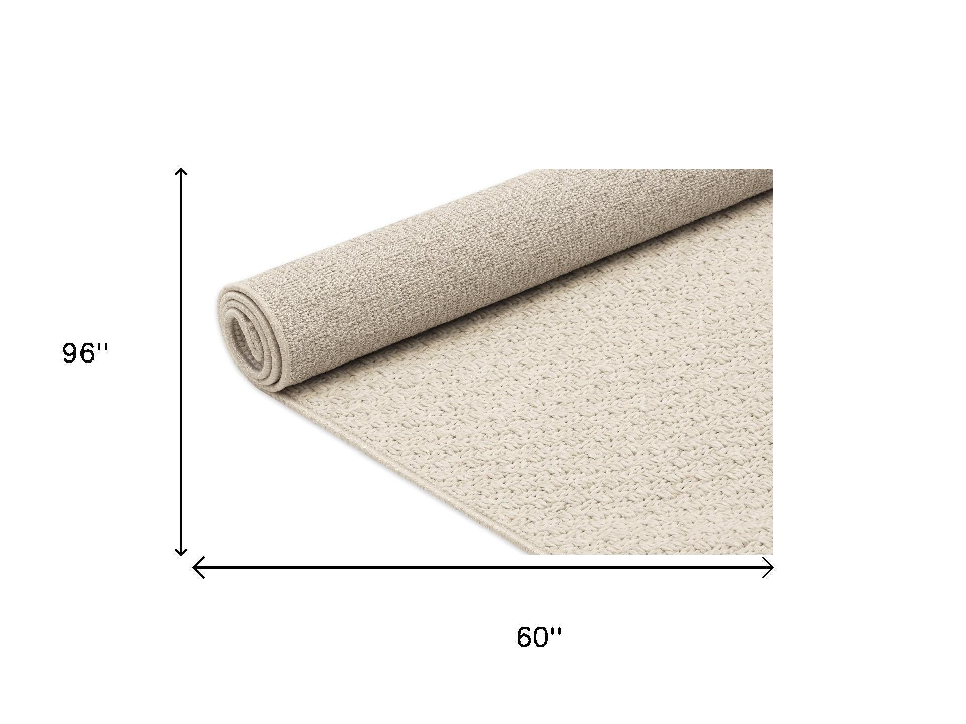 Beige woven area rug, rolled edge showing textured loop pile