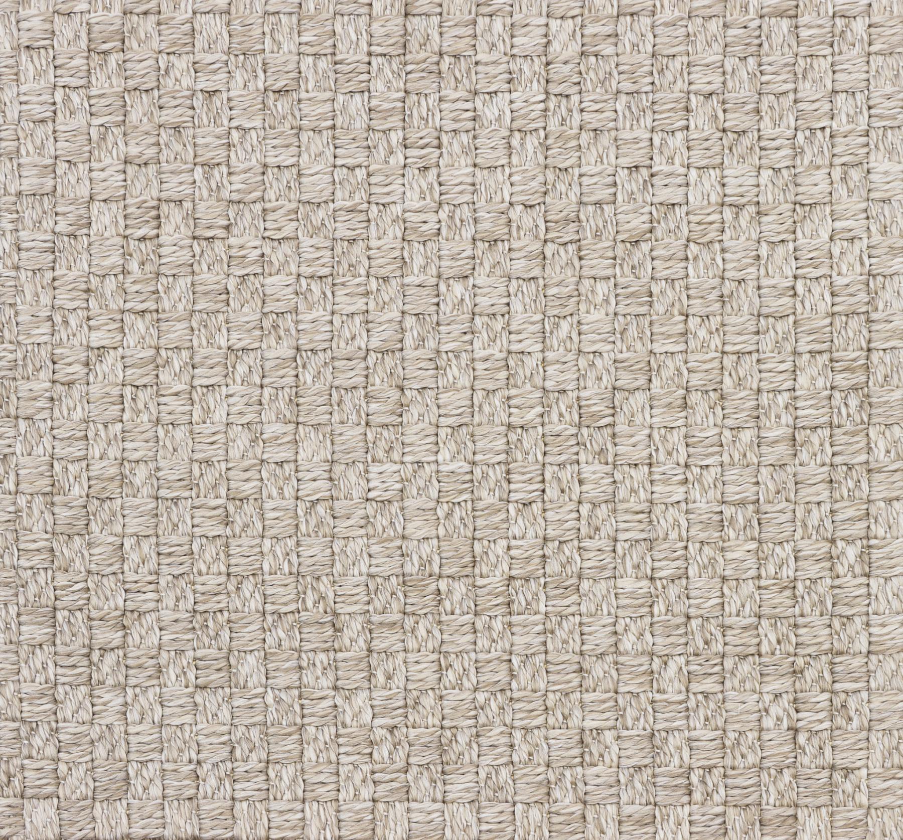Beige woven area rug texture close-up with crisscross pattern