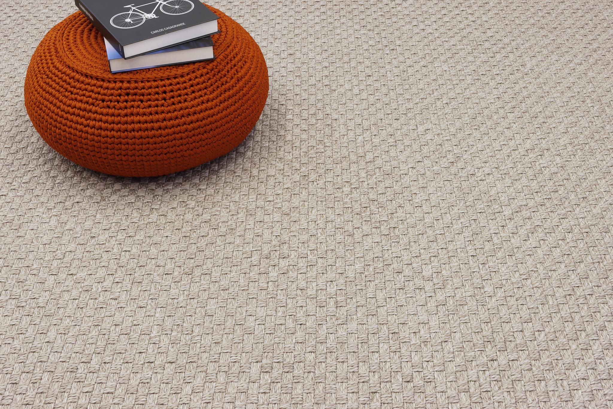 Beige woven area rug surface with tight grid-like texture