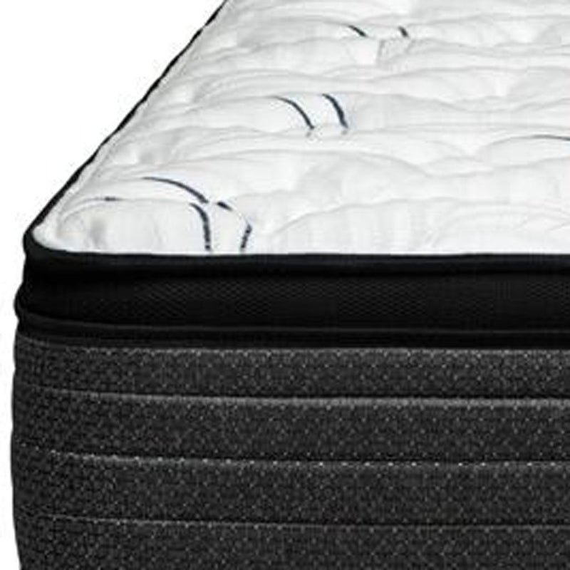 Mattress side with speckled dark fabric and white plush top