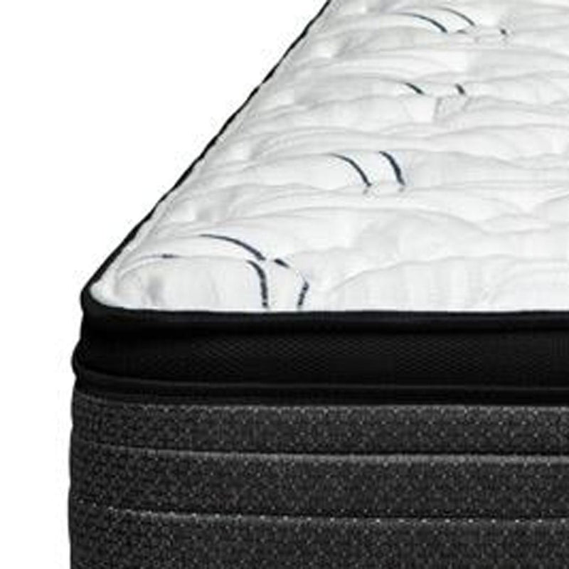 Side view close-up of white quilted top with black edge and dark charcoal layers
