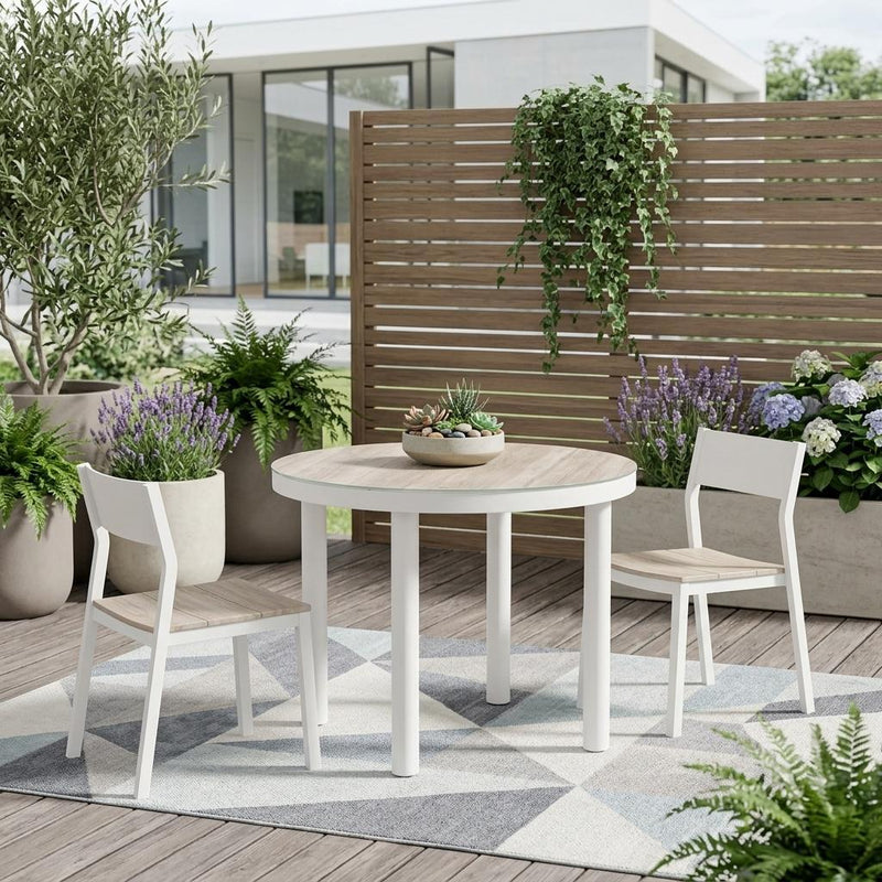 Outdoor round dining table with light wood top and white frame, with chairs