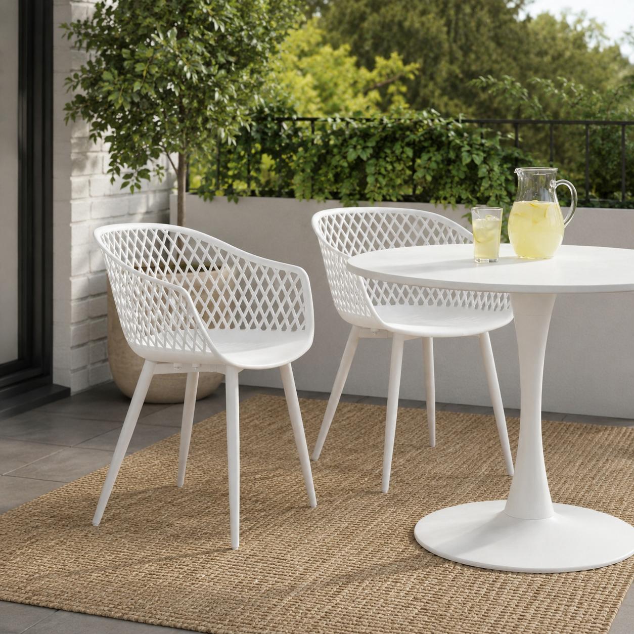 Two white plastic patio chairs with lattice backs, curved seats, and four legs