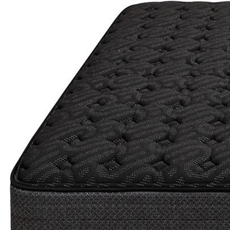Black twin mattress top close-up with quilted texture and padded edge