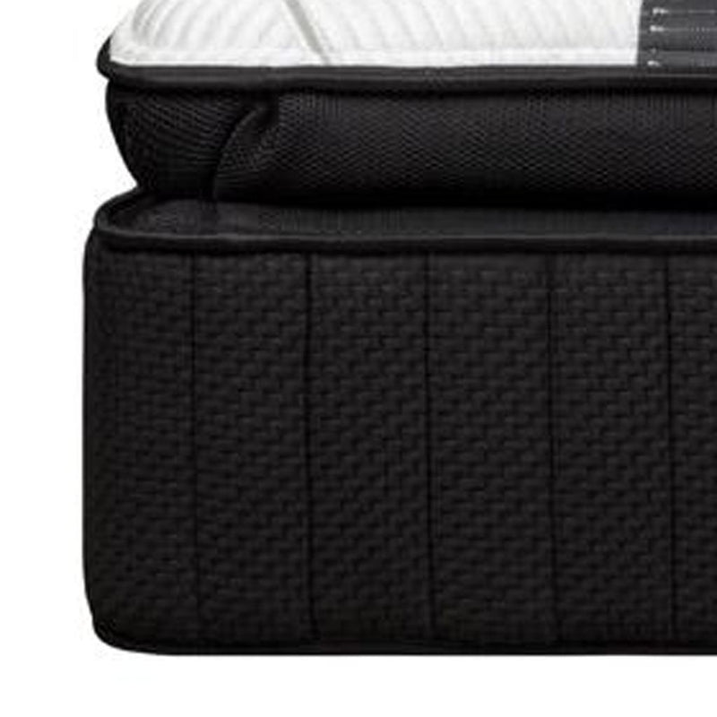 RV king mattress corner with dark black side panel and white quilted top