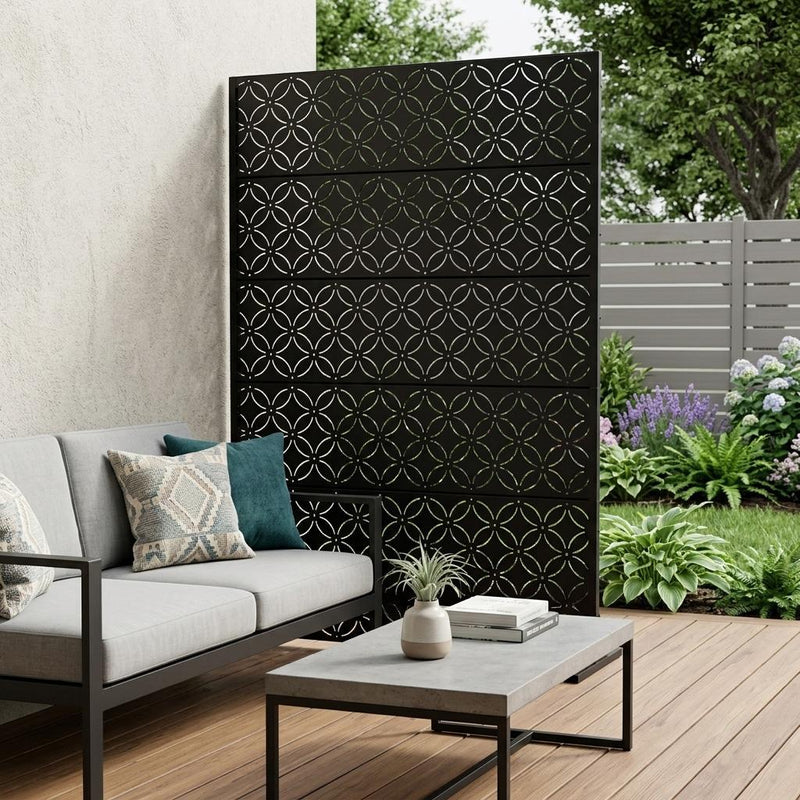 Black 12-panel outdoor privacy screen with circular lattice pattern installed in yard