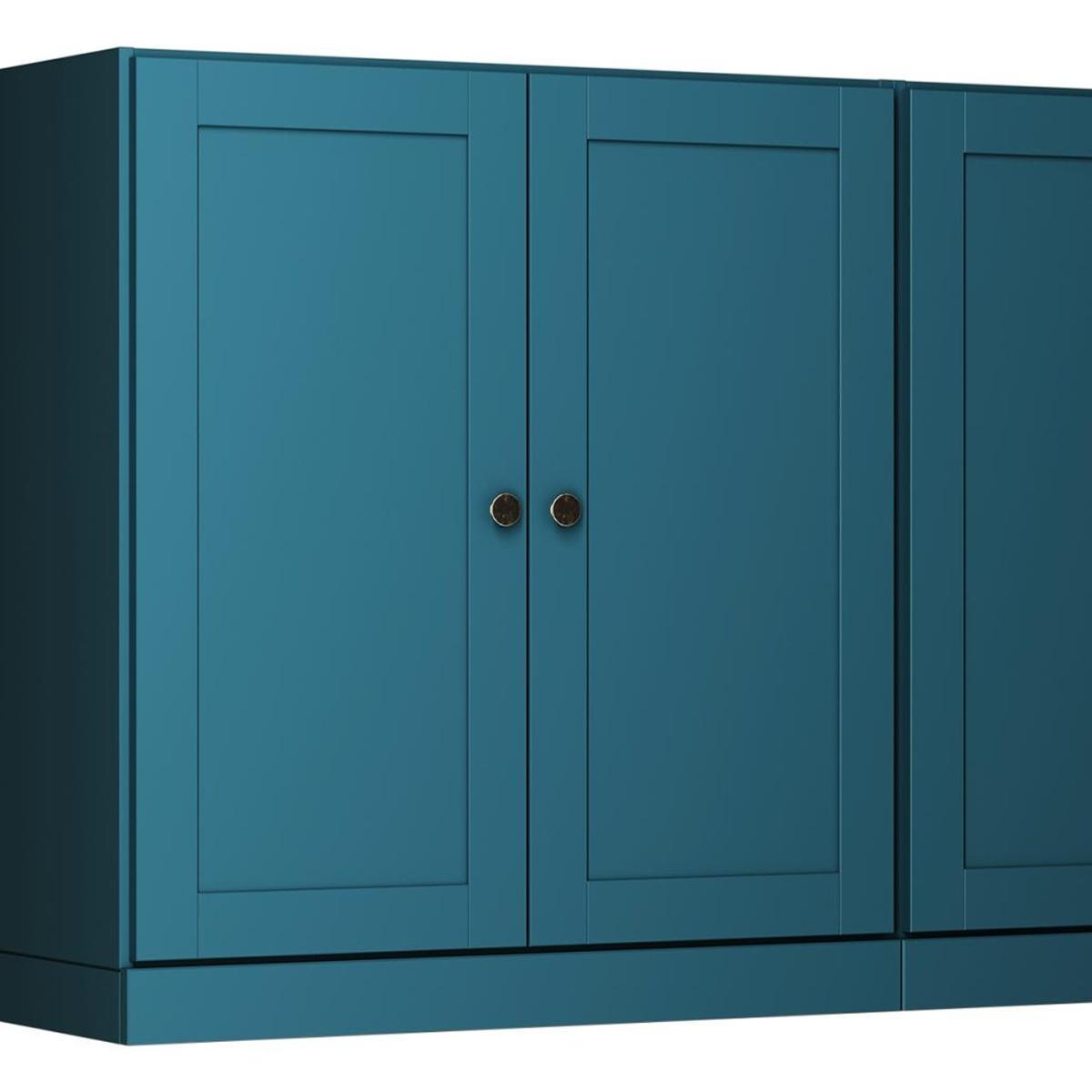 Teal blue wooden sideboard front with four doors and round brass-tone knobs