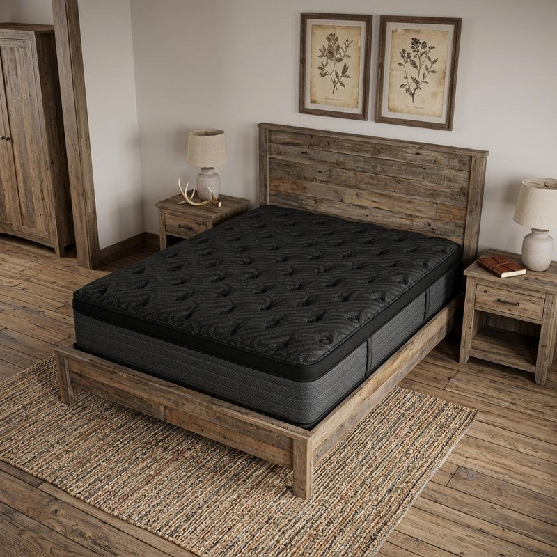 Black quilted mattress on a wooden bed frame