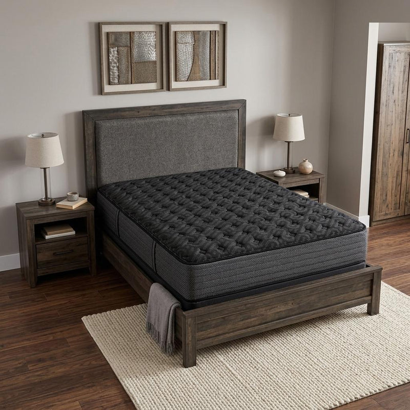 Firm hybrid mattress, dark quilted top on a wooden bed frame