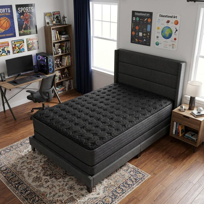 Twin hybrid mattress with black quilted top and dark base on bed