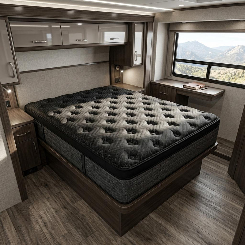 Black hybrid mattress with tufted quilted top and plush cushioning on the surface.