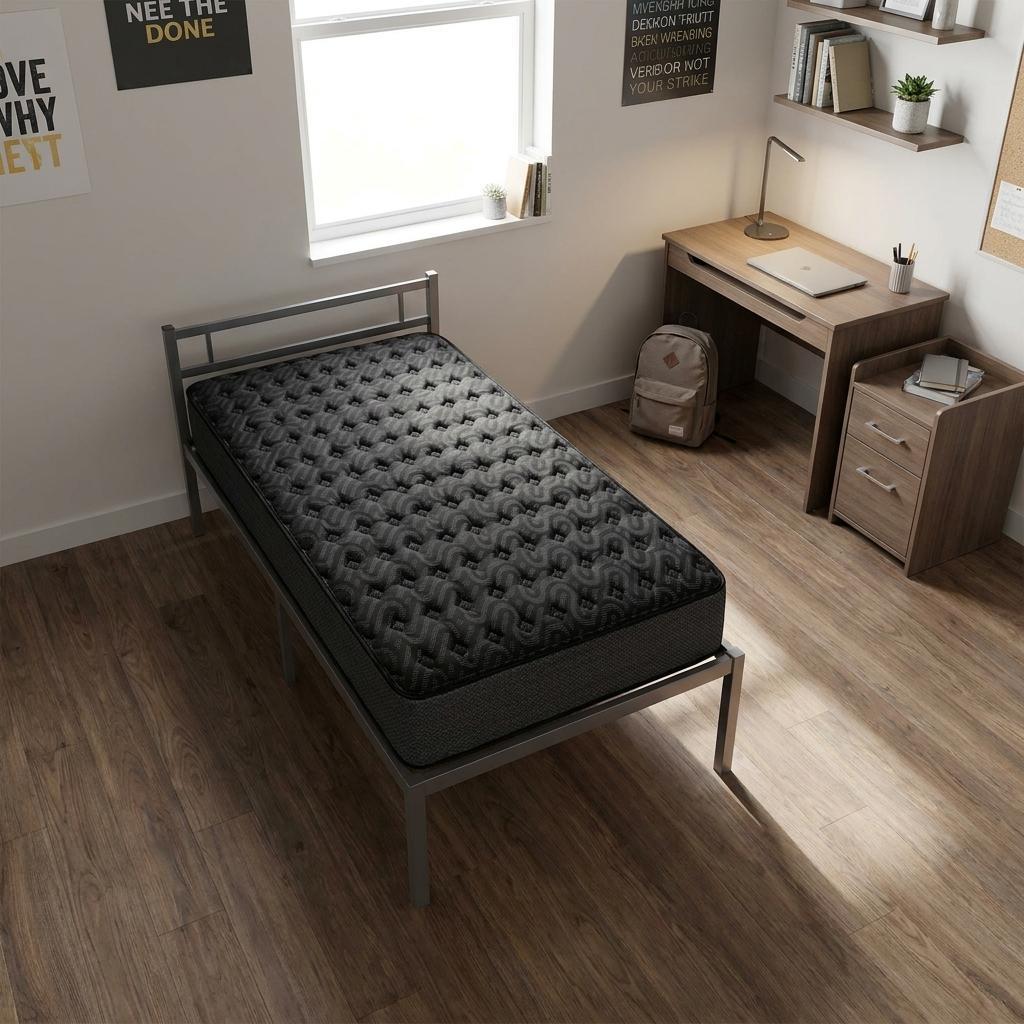 Black quilted mattress on a silver metal bed frame in a bright, minimalistic bedroom setting with wooden flooring.