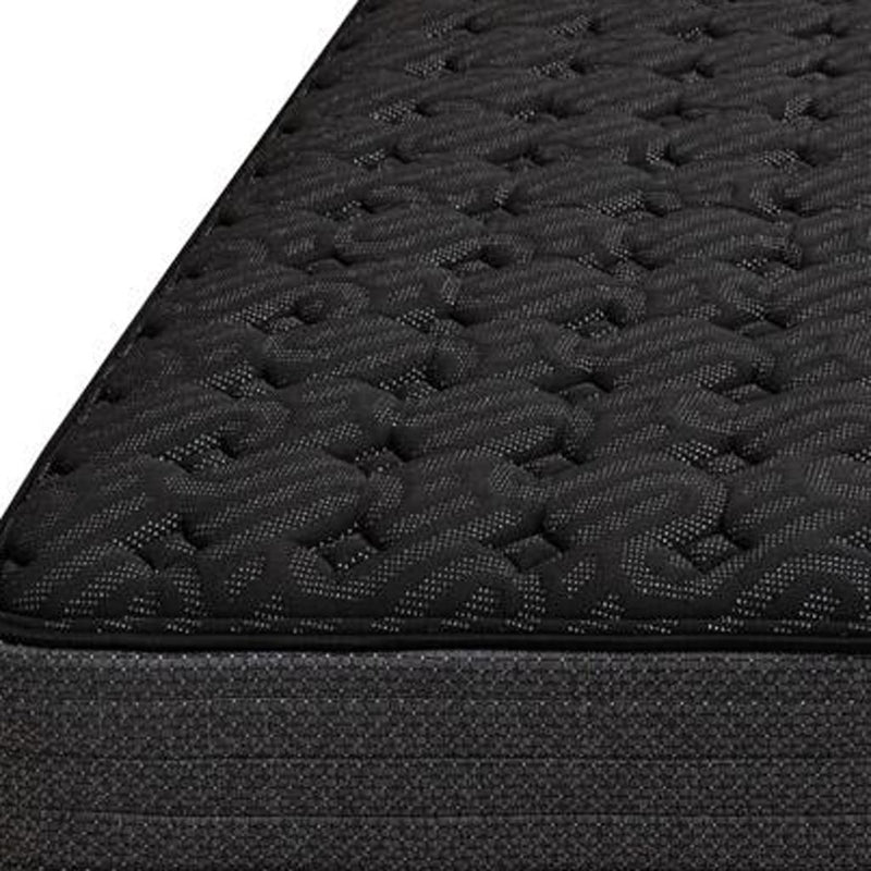 Black hybrid mattress close-up of quilted surface texture and seam edge